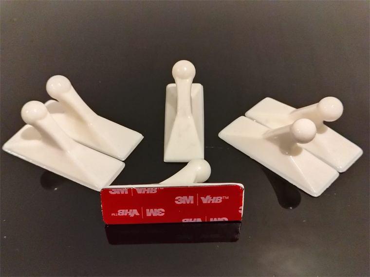Six white 3D printed coat hooks with 3M adhesive strips